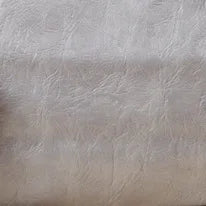 A close-up texture shot of a soft beige PU leather material.