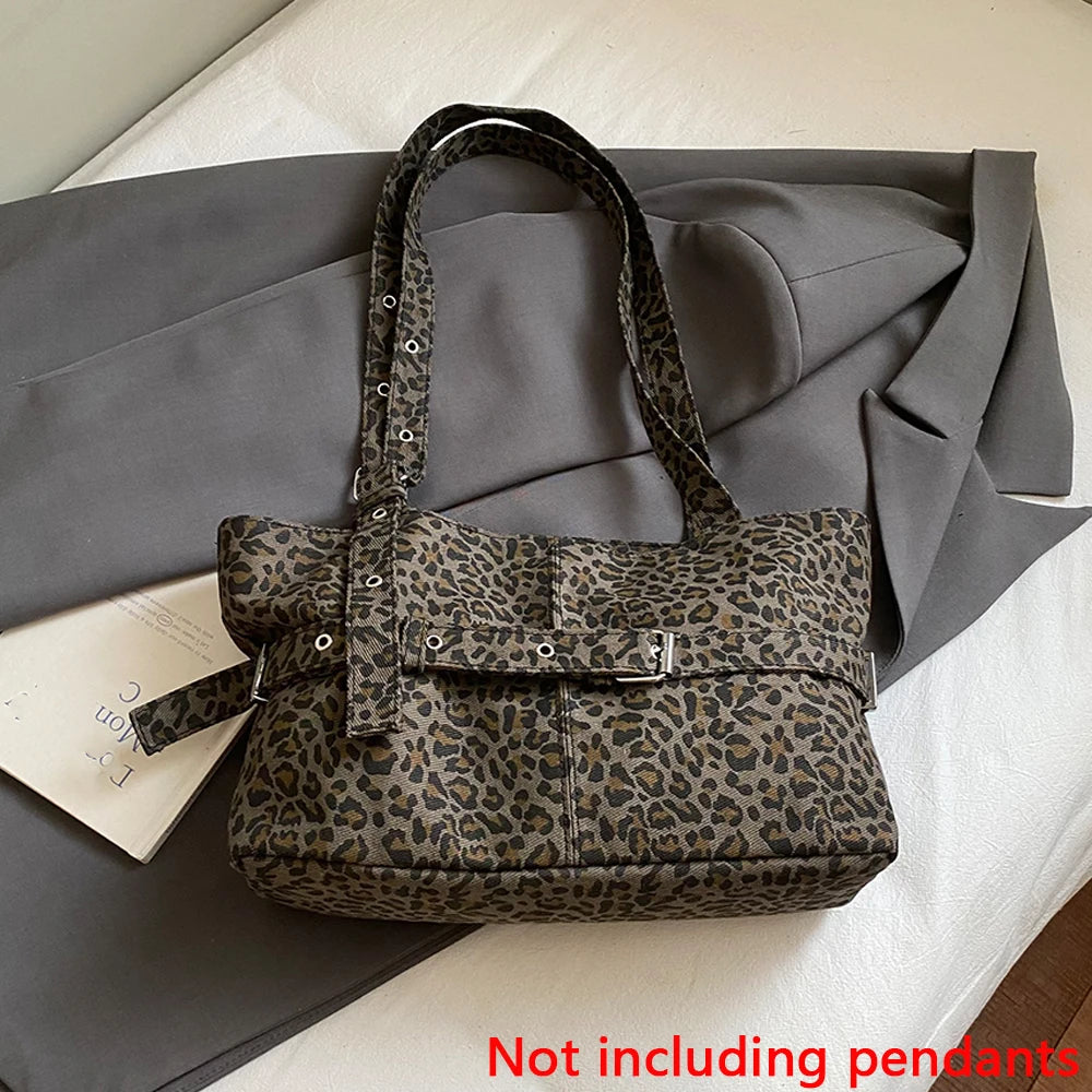 A leopard print casual tote bag in brown and black spots resting on a gray fabric with a white card.