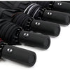 A close-up view of several black heavy-duty windproof automatic umbrellas lined up.