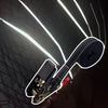 A close-up view of heavy duty ratchet tie-down straps with a black strap and metal hardware against a dark background.