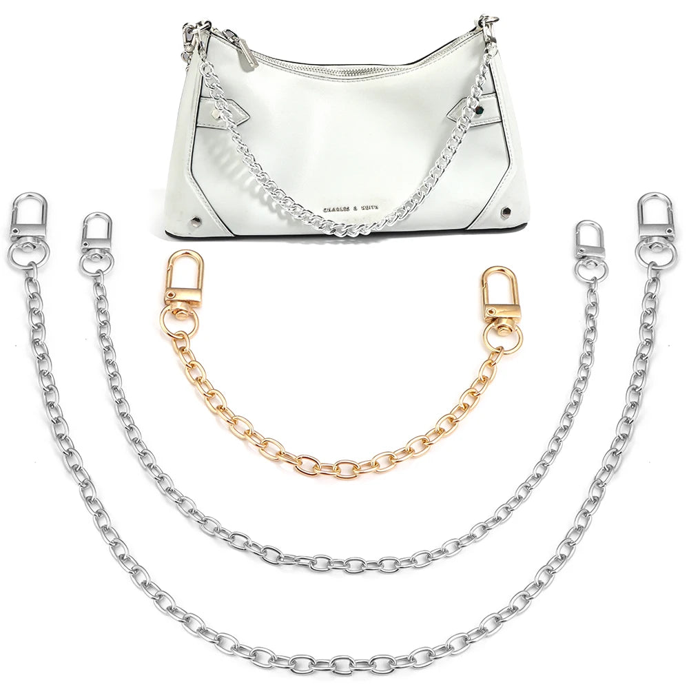 A white leather bag with silver hardware and three adjustable metal chains for strap accessories.