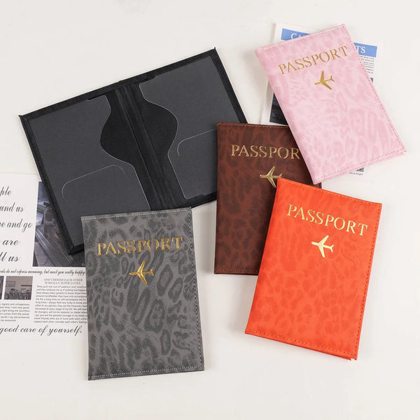 A collection of leopard print PU leather passport holders in various shades of pink, brown, and gray.