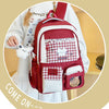 A maroon and white Oxford backpack featuring a patterned fabric, a cat design, and a small pouch.