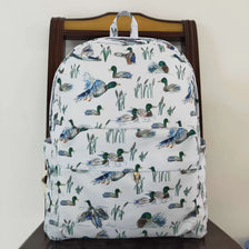 A light-colored backpack featuring a pattern of various bird and animal prints, displayed on a wooden chair.