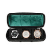 Black watch organizer case with a green velvet lining holding three watches