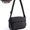 Black crossbody shoulder bag with a leather flap and chain detail.