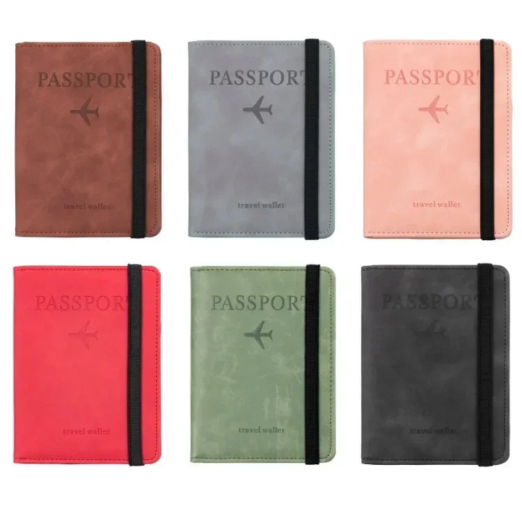 Four passport wallets in various colors including brown gray pink and dark gray leather with a plane icon