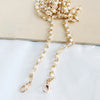 Gold and pearl adjustable chain strap jewelry displayed on a light background.