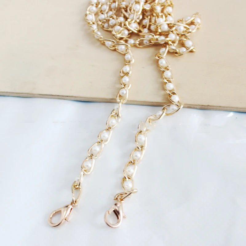 Gold and pearl adjustable chain strap jewelry displayed on a light background.