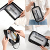 A black waterproof toiletry bag with the word WASHBAG printed on it is shown being held and used.