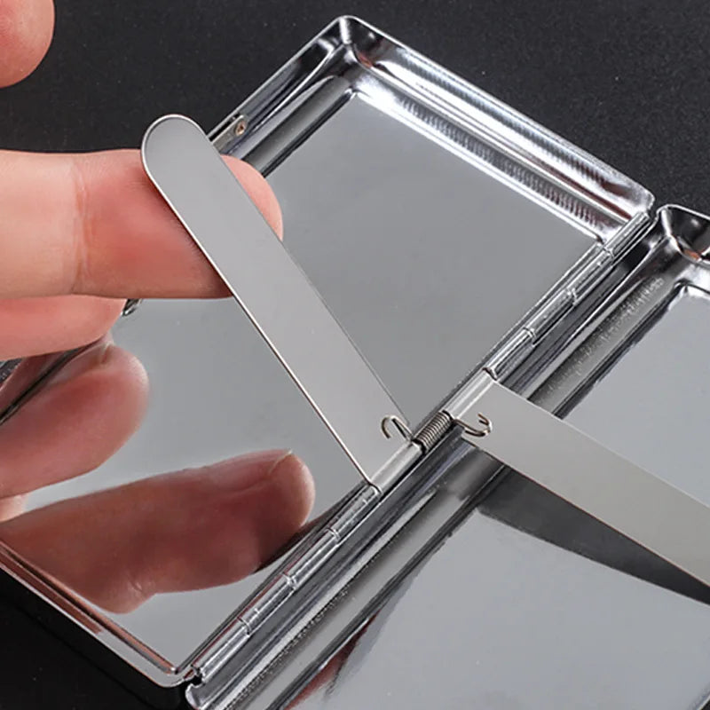 A hand opens a premium metal cigarette holder, showing the silver metal design.