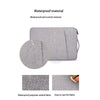 A gray waterproof and scratch resistant laptop sleeve made from polyester oxford fabric.