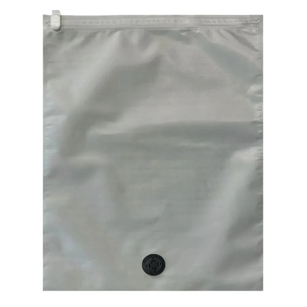 A clear reusable vacuum storage bag lying flat against a light gray background.