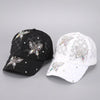 A pair of summer floral mesh snapback baseball caps in black and white with sparkling embellishments.