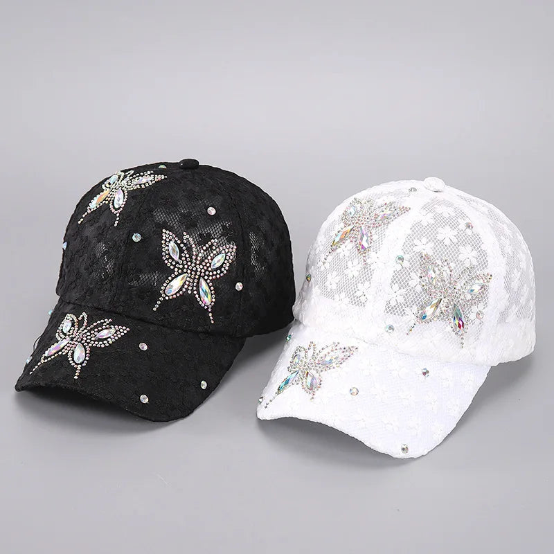 A pair of summer floral mesh snapback baseball caps in black and white with sparkling embellishments.