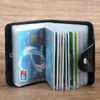A black PU leather wallet holding several plastic cards and ID documents.