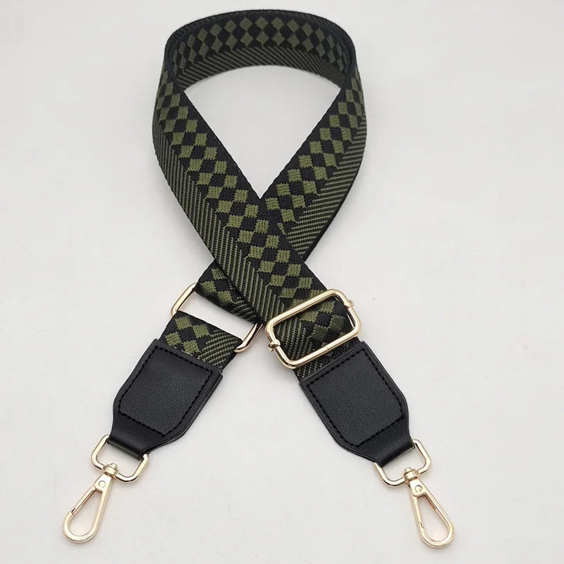 A black and olive green braided nylon strap for a bag, featuring gold-toned metal hooks.