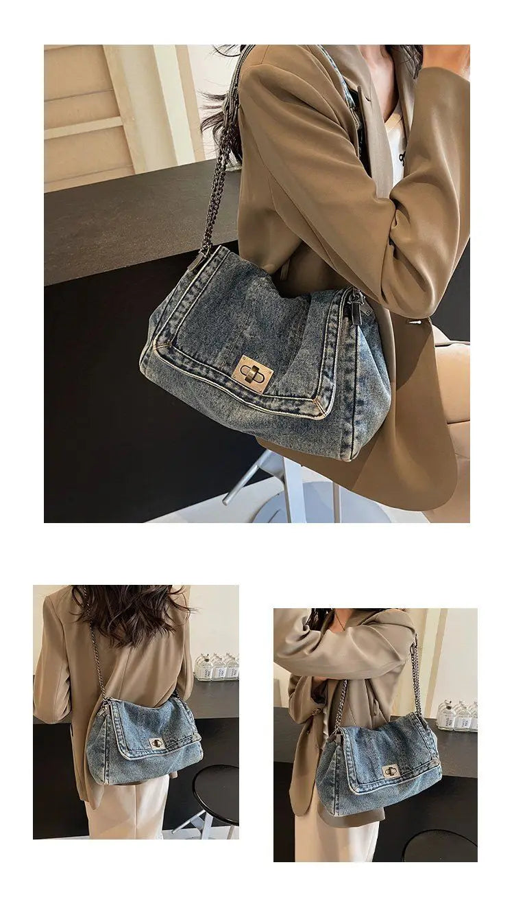 A close-up of a vintage-inspired denim tote bag with a chain strap carried by a person wearing a tan blazer.
