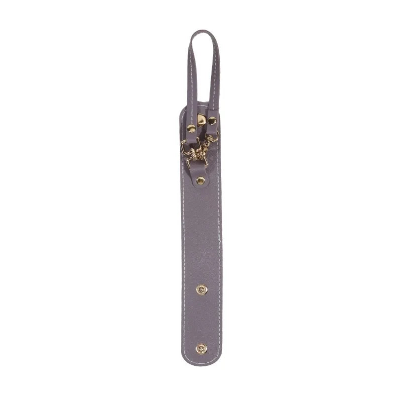 A vintage leather glove holder strap with brass hardware and a dark gray finish.