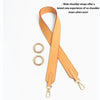 A tan adjustable wide shoulder strap is shown with attached metal rings.