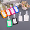A collection of colorful and clear customizable luggage tags for travel and tour groups displayed on a gray surface.