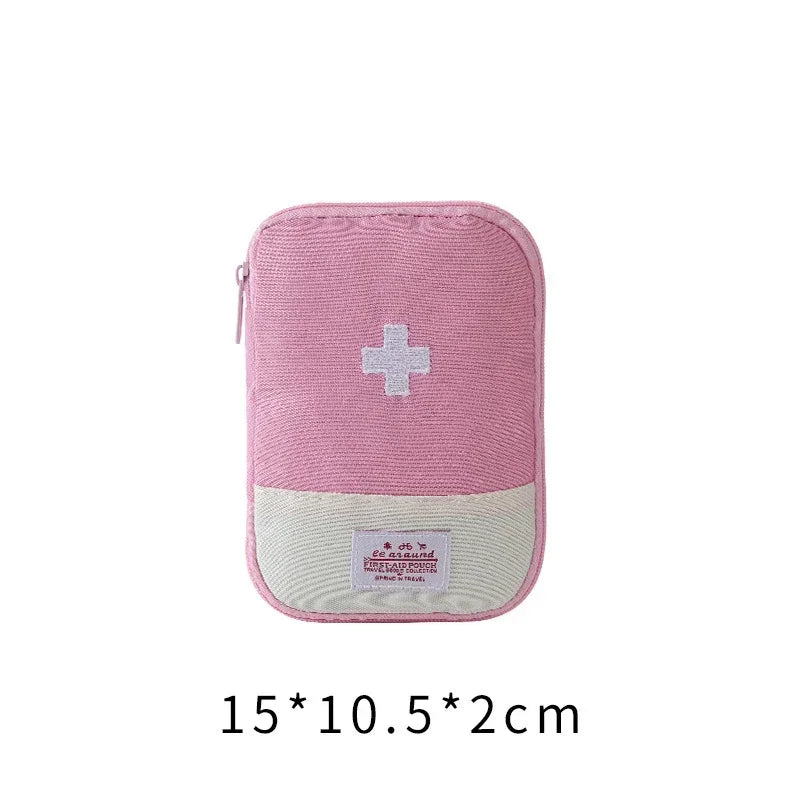 A pink fabric storage bag with a white cross emblem and a beige patch on the front.