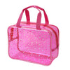 A clear waterproof makeup organizer bag with a pink glitter pattern and pink handles.