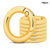 A stack of ten gold-colored metal key ring clips with spring-loaded fasteners.