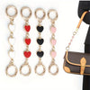 Five gold-toned heart-shaped metal chain shoulder strap extensions for handbags