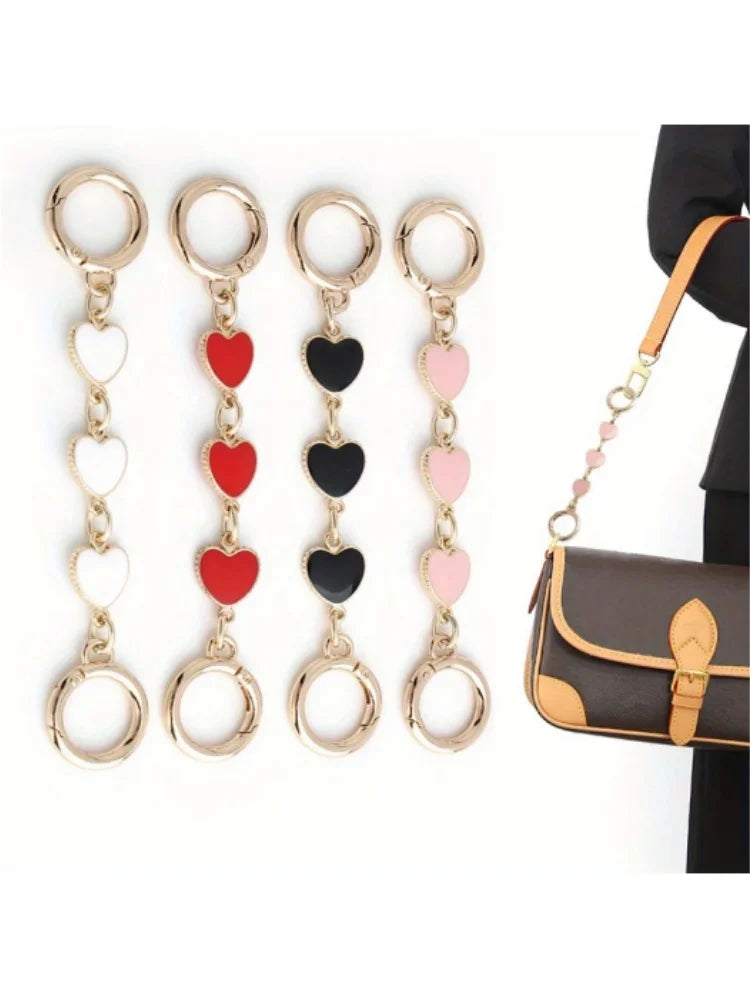 Five gold-toned heart-shaped metal chain shoulder strap extensions for handbags