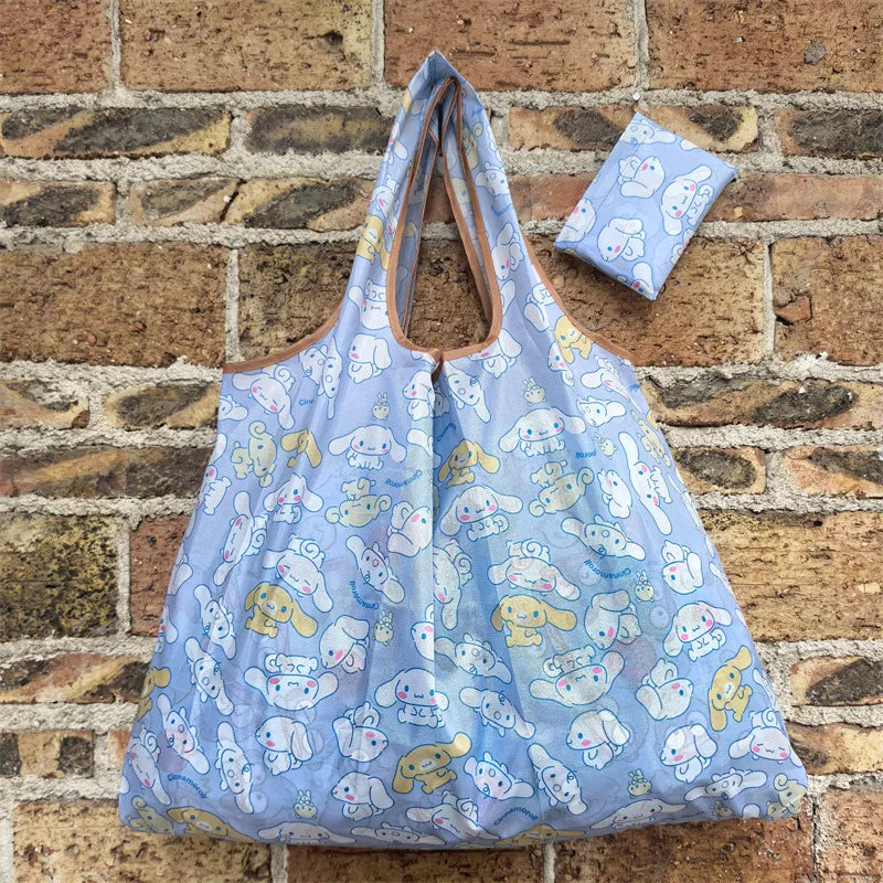 A light blue reusable shopping bag with a pattern of cute, stylized animals against a brick background.