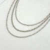 Silver punk star chain belt with pearl accents displayed on a white background.