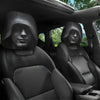 Black leopard print headrest covers installed on the front seats of a vehicle.