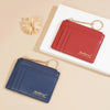 A red Baellerry card holder wallet with a gold chain is displayed next to a dark blue Baellerry wallet on a white background.