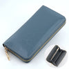 A dark blue genuine leather zipper wallet shown in a diagonal view with a close-up of the interior.