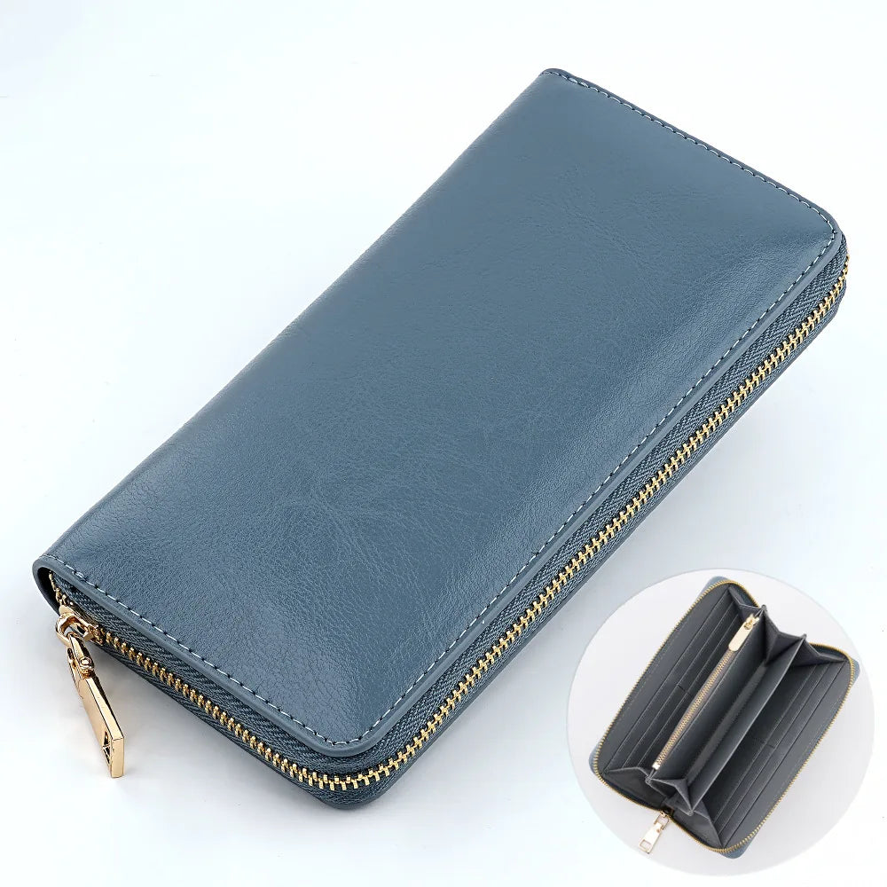 A dark blue genuine leather zipper wallet shown in a diagonal view with a close-up of the interior.