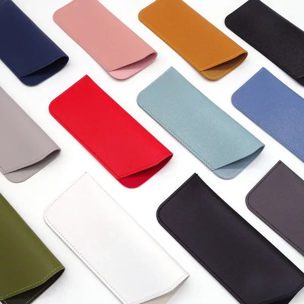 A collection of various colored PU leather eyewear cases and glasses bags arranged on a white background.