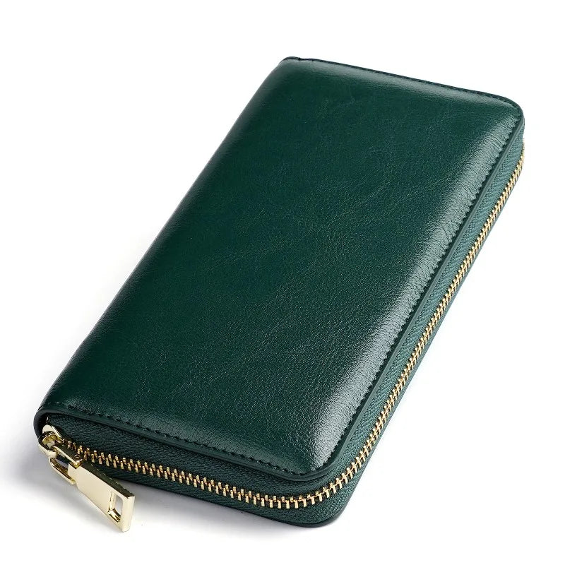 A dark green genuine leather zipper wallet shown from above.