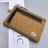 A tan RFID blocking travel wallet with a zipper and carabiner attached, shown against a white background.