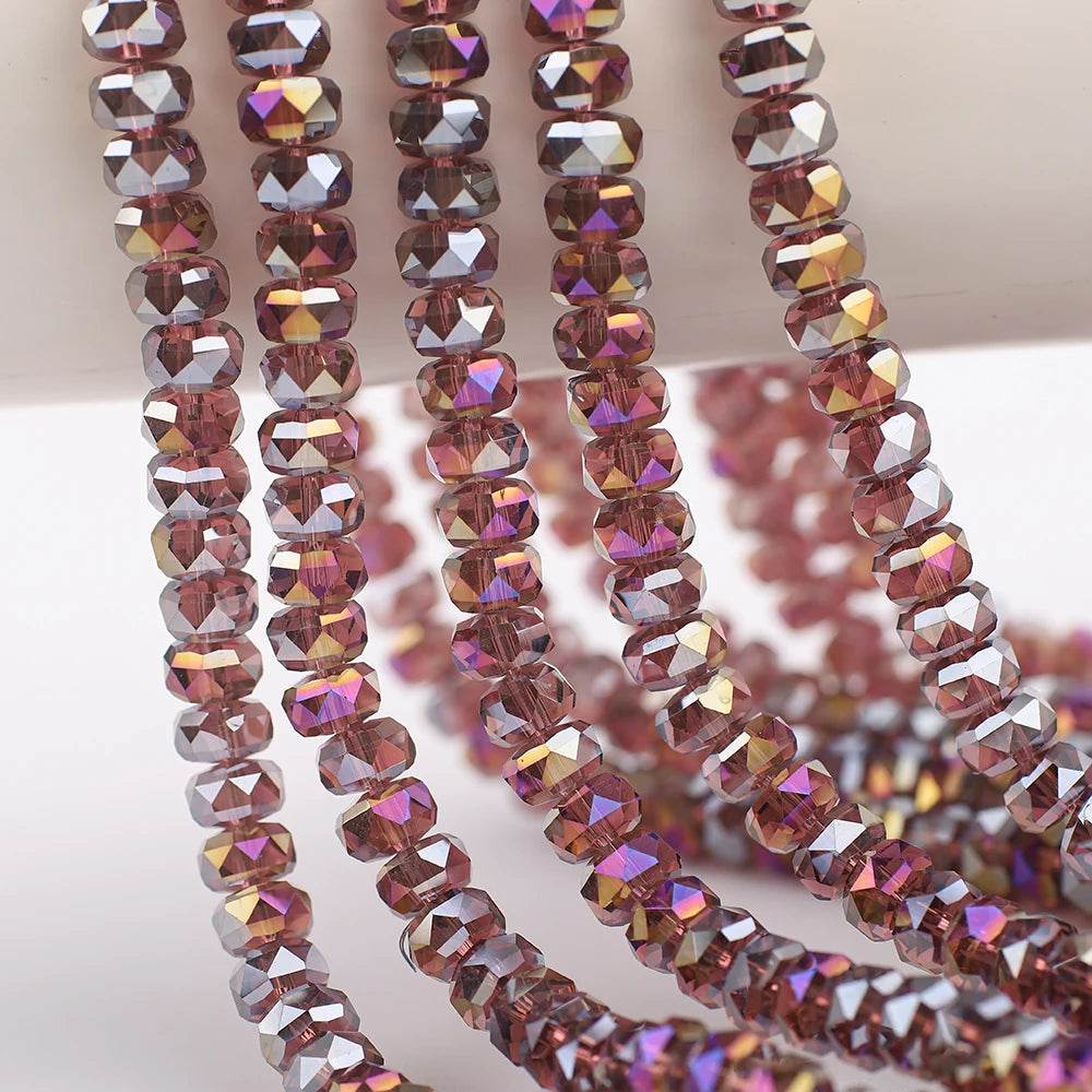 Strands of faceted crystal glass beads in shades of pink and purple with a wheel shape for jewelry making