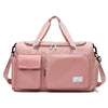 A pink large capacity travel duffle bag with padded compartments and shoulder straps.