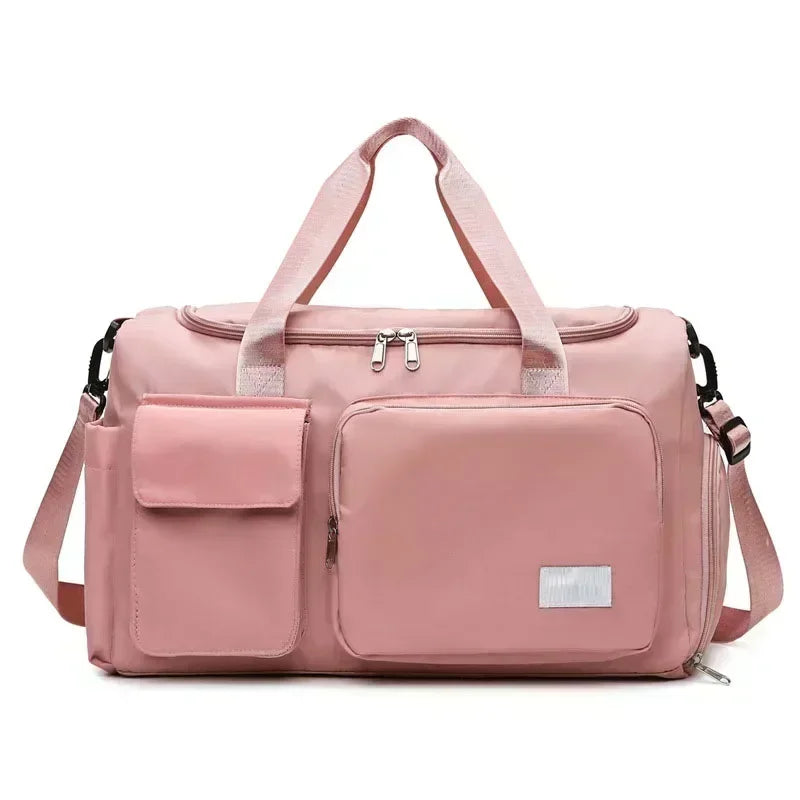 A pink large capacity travel duffle bag with padded compartments and shoulder straps.