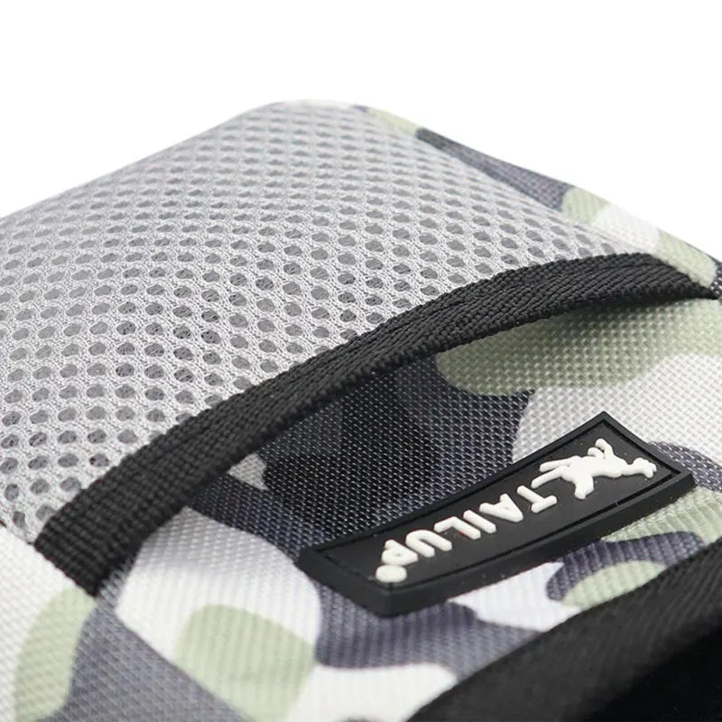 A close-up view of a black pet training treat pouch for dogs with a camouflage pattern.