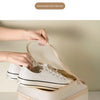A beige portable luggage shoe organizer bag is shown open, revealing a pair of white sneakers inside.