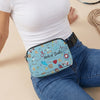 A light blue medical doodle print crossbody waist bag worn by a person in a white top and jeans.