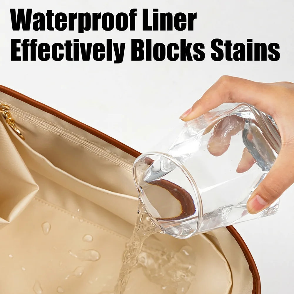 A hand pours water into a tan leather tote bag, demonstrating the waterproof liner effectively blocks stains.
