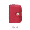 A red leather wallet with a snap closure and a silver coin-shaped button.