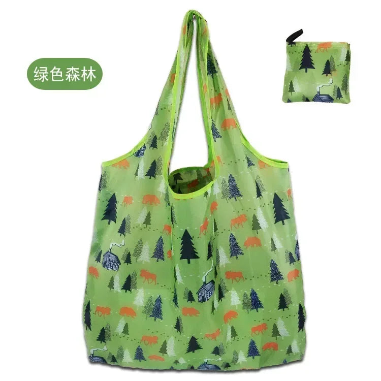 A light green fabric tote bag featuring a repeating pattern of forest animals and trees.