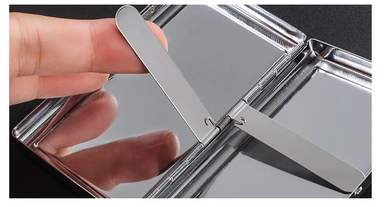 A hand opens a premium metal cigarette holder, showing the sliding mechanism and reflective surface.