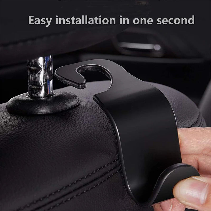 A close-up of a black car seat back hook being installed on a leather seat fabric.